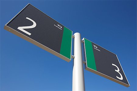 Signpost on a railway station with out of focus blue sky Foto de stock - Royalty-Free Super Valor e Assinatura, Número: 400-06699562