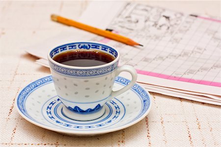 simsearch:400-04849433,k - A cup of coffee and a newspaper with a pencil on it. Stockbilder - Microstock & Abonnement, Bildnummer: 400-06699698