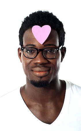 eyeglasses forehead - Closeup of an african man with pink paper heart on forehead isolated over white Photographie de stock - Aubaine LD & Abonnement, Code: 400-06699820