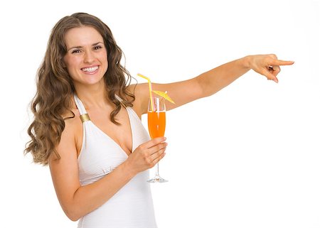 simsearch:400-06772308,k - Smiling young woman in swimsuit with cocktail pointing on copy space Stockbilder - Microstock & Abonnement, Bildnummer: 400-06699899