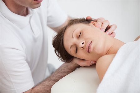 Woman being massaging by the doctor while having the head turn in the side inddor Stockbilder - Microstock & Abonnement, Bildnummer: 400-06690000