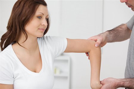 Doctor examining the arm of his patient in a room Stock Photo - Budget Royalty-Free & Subscription, Code: 400-06690028