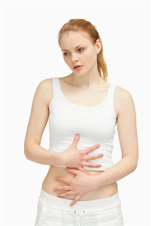 simsearch:400-06690149,k - Serious woman placing her hands on her stomach Stock Photo - Budget Royalty-Free & Subscription, Code: 400-06690131