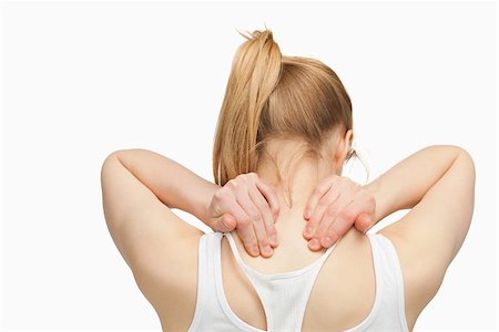 simsearch:400-06690149,k - Woman massaging her nape with her hands against white background Stock Photo - Budget Royalty-Free & Subscription, Code: 400-06690146