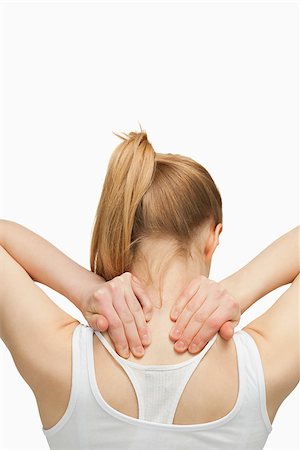 simsearch:400-06690149,k - Blonde woman massaging her painful neck against white background Stock Photo - Budget Royalty-Free & Subscription, Code: 400-06690147