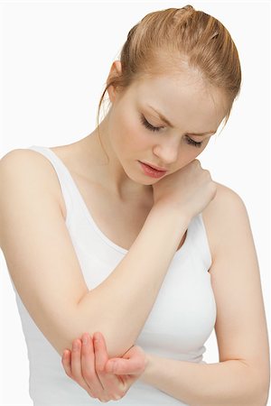 simsearch:400-06690149,k - Woman touching her painful elbow against white background Stock Photo - Budget Royalty-Free & Subscription, Code: 400-06690148