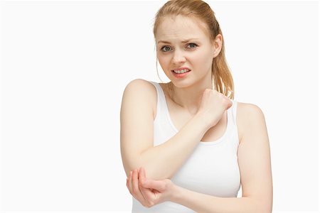 simsearch:400-06690149,k - Fair-haired woman touching her elbow Stock Photo - Budget Royalty-Free & Subscription, Code: 400-06690153