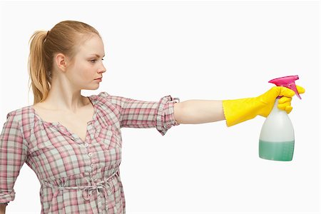 serious maid - Joyful woman holding a spray bottle against white background Stock Photo - Budget Royalty-Free & Subscription, Code: 400-06690198