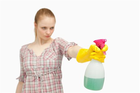 serious maid - Serious woman holding a spray bottle against white background Stock Photo - Budget Royalty-Free & Subscription, Code: 400-06690199