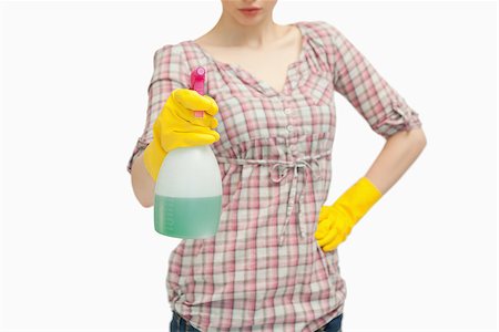 serious maid - Close up of a woman holding a spray bottle against white background Stock Photo - Budget Royalty-Free & Subscription, Code: 400-06690202