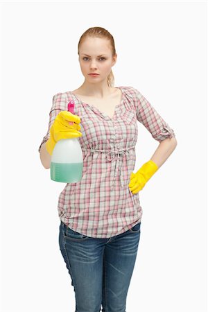 serious maid - Serious woman holding a spray bottle while standing against white background Stock Photo - Budget Royalty-Free & Subscription, Code: 400-06690203