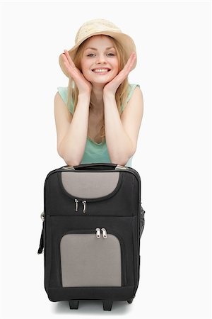 simsearch:6109-06003072,k - Smiling woman leaning on a suitcase while sitting against white background Photographie de stock - Aubaine LD & Abonnement, Code: 400-06690225