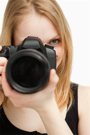 people holding camera slr - Close up of a woman holding a camera against white background Stock Photo - Budget Royalty-Free & Subscription, Code: 400-06690232