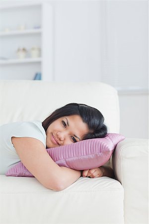 Woman relaxing on a sofa with her head on a pillow in a living room Stock Photo - Budget Royalty-Free & Subscription, Code: 400-06690626