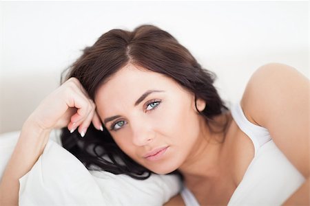 simsearch:400-04903640,k - Serious woman lying on her bed in a bright bedroom Stock Photo - Budget Royalty-Free & Subscription, Code: 400-06690742