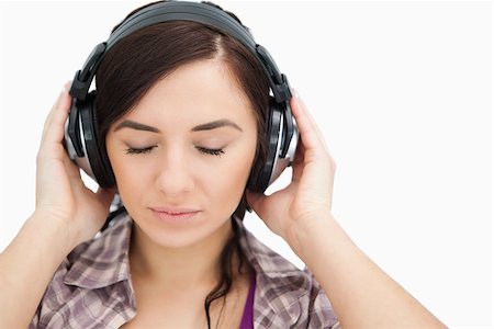 simsearch:400-06690896,k - Brunette with headphones closing her eyes against white background Stock Photo - Budget Royalty-Free & Subscription, Code: 400-06690902