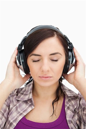 simsearch:400-06690896,k - Woman with headphones enjoying music the eyes closed against white backgorund Stock Photo - Budget Royalty-Free & Subscription, Code: 400-06690903