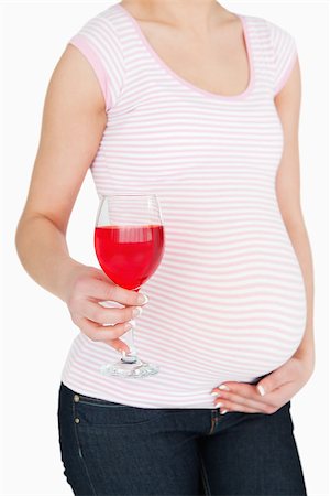 simsearch:400-06690931,k - Pregnant woman with a non-alcoholic drink against white background Fotografie stock - Microstock e Abbonamento, Codice: 400-06690934