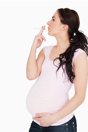 Young pregnant woman smoking against white background Stockbilder - Microstock & Abonnement, Bildnummer: 400-06690938