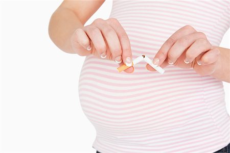 simsearch:400-06690931,k - Young woman stop to smoke while she is pregnant against white background Fotografie stock - Microstock e Abbonamento, Codice: 400-06690941