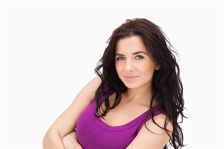 simsearch:400-06690896,k - Beautiful brunette with folded arms against white background Stock Photo - Budget Royalty-Free & Subscription, Code: 400-06690984