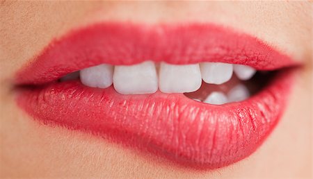 Close-up of the white teeth of a woman biting her lips Stock Photo - Budget Royalty-Free & Subscription, Code: 400-06691106