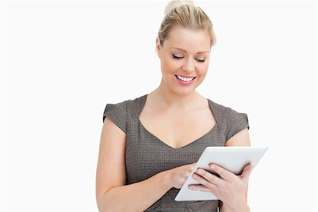 simsearch:400-06802290,k - Woman looking at a tablet computer against white background Stock Photo - Budget Royalty-Free & Subscription, Code: 400-06691466