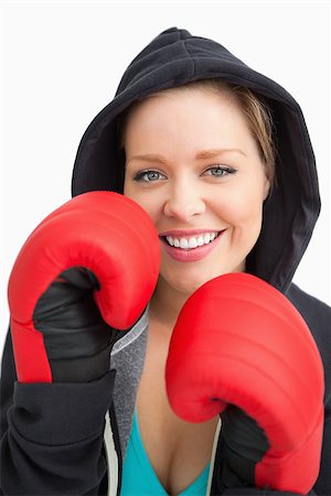 Pretty smiling woman boxing against white background Stock Photo - Budget Royalty-Free & Subscription, Code: 400-06691496