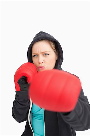 simsearch:400-06876600,k - Concentrated woman boxing against white background Stock Photo - Budget Royalty-Free & Subscription, Code: 400-06691504