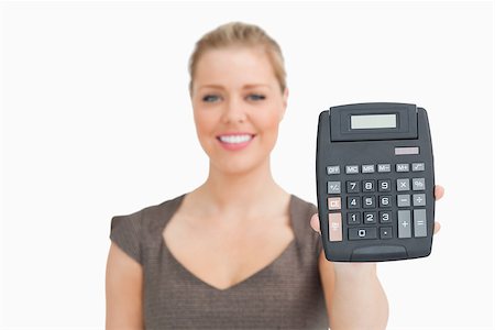 simsearch:400-04204809,k - Woman showing a calculator in her hand against white background Stock Photo - Budget Royalty-Free & Subscription, Code: 400-06691534