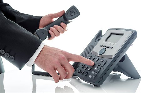 Male hand dialing number on a black phone against a white background. Stockbilder - Microstock & Abonnement, Bildnummer: 400-06692257