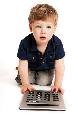 Cute boy doing maths with big calculator. Stock Photo - Budget Royalty-Free & Subscription, Code: 400-06692517