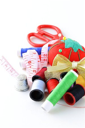 remnant - sewing utensils - coils colored threads, pins, thimble Stock Photo - Budget Royalty-Free & Subscription, Code: 400-06693803