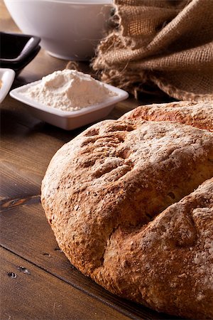 Fresh rustic baked bread and ingredients on a wooden table Stock Photo - Budget Royalty-Free & Subscription, Code: 400-06693850
