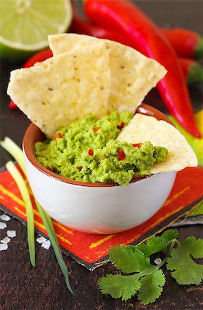 eating chips dip - Fresh guacamole dip with nacho chips and ingredients. Stock Photo - Budget Royalty-Free & Subscription, Code: 400-06701411