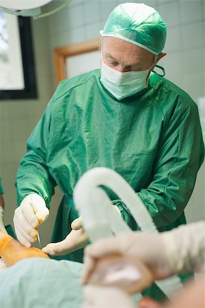 Surgeon operating a patient in a surgical room Stock Photo - Budget Royalty-Free & Subscription, Code: 400-06734014