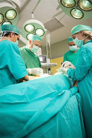 Medical team operating a patient in a surgical room Stock Photo - Budget Royalty-Free & Subscription, Code: 400-06734017