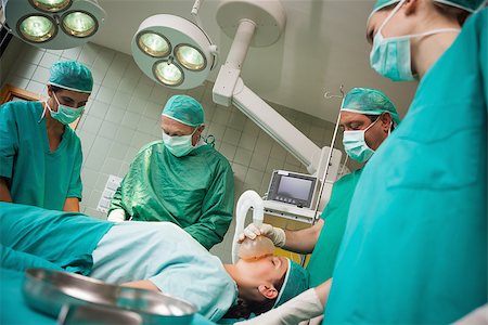 Surgeon holding a mask on the face of a woman in a surgical room Stock Photo - Budget Royalty-Free & Subscription, Code: 400-06734073