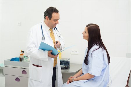 Patient listening to a doctor in an examination room Stock Photo - Budget Royalty-Free & Subscription, Code: 400-06734124