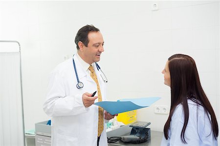 Doctor and patient talking together in an examination room Stock Photo - Budget Royalty-Free & Subscription, Code: 400-06734126