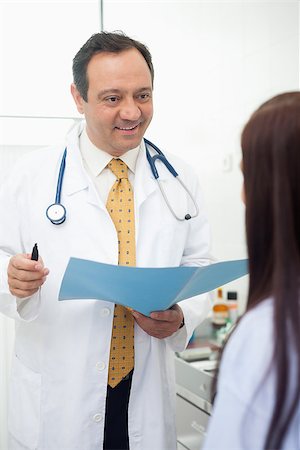 Smiling doctor talking to his patient in an examination room Stock Photo - Budget Royalty-Free & Subscription, Code: 400-06734127