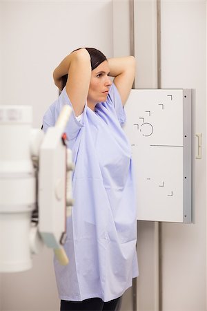 sonography lab coat - Woman placing her arms on her head while standing in front of a machine in an examination room Stock Photo - Budget Royalty-Free & Subscription, Code: 400-06734129