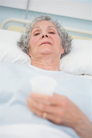 Elderly patient looking at camera in hospital ward Stock Photo - Budget Royalty-Free & Subscription, Code: 400-06734204