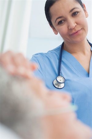 Smiling nurse looking at a patient in hospital ward Stock Photo - Budget Royalty-Free & Subscription, Code: 400-06734225