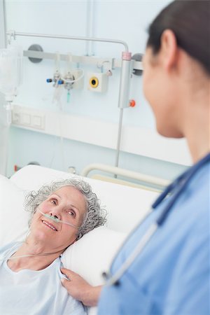 Smiling patient looking at a nurse in hospital ward Stock Photo - Budget Royalty-Free & Subscription, Code: 400-06734226