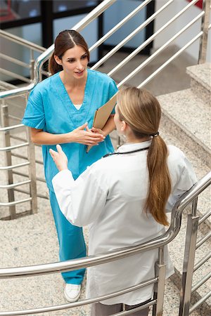 simsearch:400-06875952,k - Woman nurse and doctor talking in a stairwell in a hospital Stockbilder - Microstock & Abonnement, Bildnummer: 400-06734230