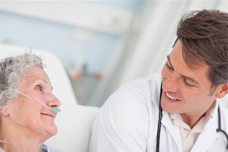 Close up of a doctor looking at a patient in hospital ward Stock Photo - Budget Royalty-Free & Subscription, Code: 400-06734288