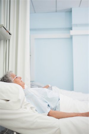 Patient lying on a medical bed in hospital ward Stock Photo - Budget Royalty-Free & Subscription, Code: 400-06734398