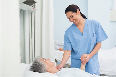 Nurse holding the hand of a patient in hospital ward Stock Photo - Budget Royalty-Free & Subscription, Code: 400-06734393