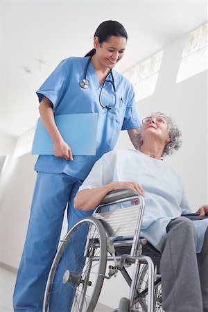 simsearch:400-07337135,k - Elderly patient in a wheelchair next to a nurse in hospital ward Stock Photo - Budget Royalty-Free & Subscription, Code: 400-06734416